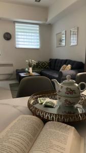 a table with two open books and a tea pot on it at TIM Apartment Sarajevo with private parking in Sarajevo