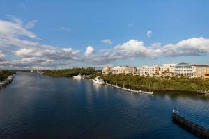 an aerial view of a river with buildings and condos at Wyndham Grand Jupiter at Harbourside Place in Jupiter