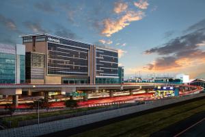 a large building with a train in front of it at Sheraton Manila Hotel at Newport World Resorts in Manila