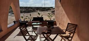 a table and chairs with a view of the beach at Relax e tranquillità a Cala Pisana in Lampedusa