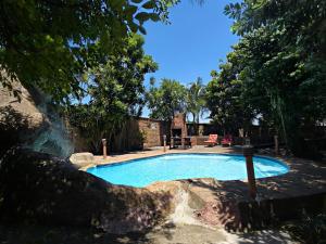 a swimming pool in the middle of a yard at Forest Lodge - Richards Bay in Richards Bay