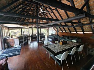 a room with a table and chairs in a building at Forest Lodge - Richards Bay in Richards Bay +3 photos