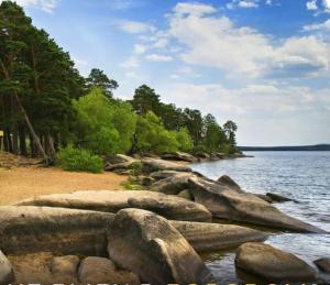 a group of rocks on the shore of a body of water at База отдыха Golden rest in Borovoye