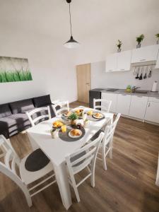 a white table and chairs in a living room at apartma Vila TARA in Prebold