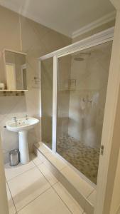 a bathroom with a shower and a sink at Amber Selfcatering in Clarens +50 photos