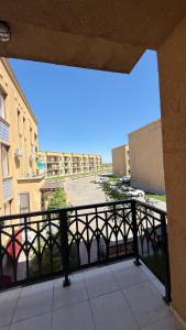 a balcony with a view of a parking lot at Yassi Apartment in Türkistan