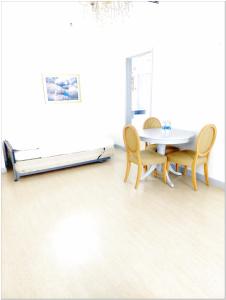 a dining room with a table and chairs and a bed at Concord service suite time square in Kuala Lumpur