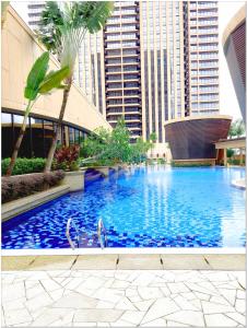 a large swimming pool in a city with tall buildings at Concord service suite time square in Kuala Lumpur