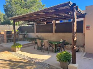 a patio with a table and chairs under a pergola at Casita in Illes Balears