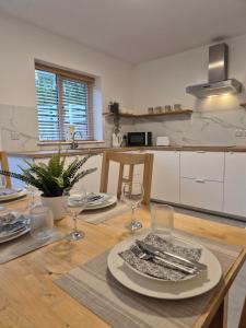 a kitchen with a table with plates and glasses on it at Waterfall Cottage in Killybegs