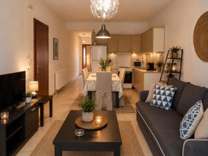 a living room with a couch and a table at Angel Luxury Apartments in Keramoti