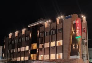 a building with lights on top of it at night at Hotel Agam-Railway Station Kota in Tīrath