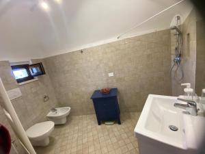 a bathroom with a sink and a toilet and a sink at Trullo Raimondo in Martina Franca +22 photos