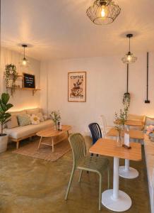 a living room with tables and a couch at The Highdogs Hostel in Phi Phi Islands