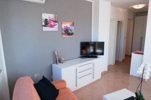 a living room with a couch and a flat screen tv at Apartment Lexi in Rovinj