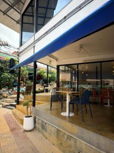 a restaurant with a table and chairs on a patio at The Highdogs Hostel in Phi Phi Islands
