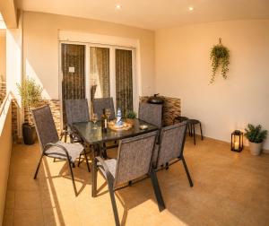 a dining room with a table and chairs at Angel Luxury Apartments in Keramoti