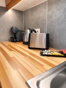 a kitchen counter with a toaster and a tea kettle at Panos Villas in Koukounaries