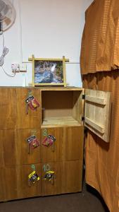a room with two cardboard boxes next to a bed at Waves & Paws Hostel in Arugam Bay