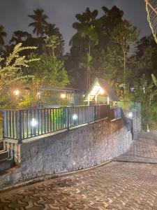 a fence on a stone wall at night at Beloved Regency Homestay in Kandy +5 photos