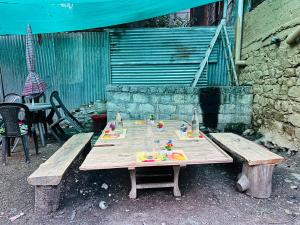 a wooden table with food on top of it at Pond & Stone Homestay in Banjār