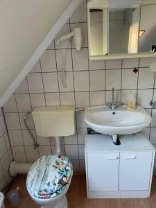 a bathroom with a sink and a toilet at Kamilla Apartman in Fonyód