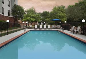 a swimming pool at a hotel with chairs at Hampton Inn & Suites Natchez in Natchez