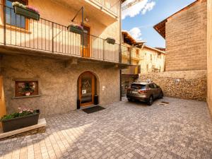 a car parked in a parking lot next to a building at Sweet Alps in Tirano