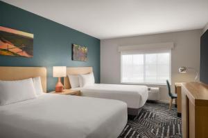 a hotel room with two beds and a window at Hyatt House Fishkill-Poughkeepsie in Fishkill