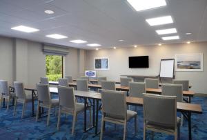 a conference room with tables and chairs and a screen at Hampton Inn & Suites Natchez in Natchez +26 photos