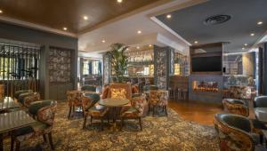 a bar with chairs and tables and a fireplace at Hilton Dublin in Dublin