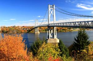 a suspension bridge over a river with trees at Hyatt House Fishkill-Poughkeepsie in Fishkill +49 photos