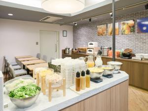 a kitchen with a bunch of food on a counter at Comfort Hotel Himeji in Himeji