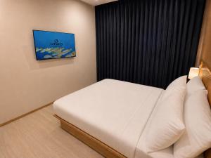 a bedroom with a white bed in a room at Isola Alifu in Feridhoo +10 photos