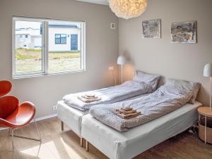 a bedroom with a bed with two towels on it at Deluxe Family Apartment in Egilsstaðir in Egilsstaðir