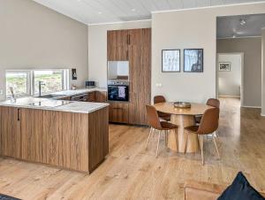a kitchen and dining room with a table and chairs at Deluxe Family Apartment in Egilsstaðir in Egilsstaðir