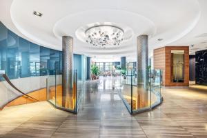 a lobby with glass columns and a chandelier at Doubletree By Hilton London Kensington in London