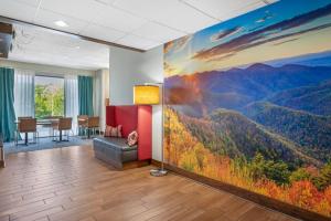 an office with a large painting of a mountain view at Clarion Pointe Cherokee in Cherokee