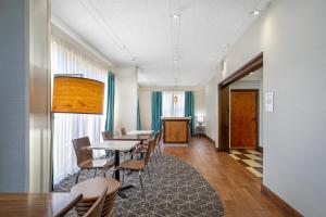 a conference room with tables and chairs and a podium at Clarion Pointe Cherokee in Cherokee
