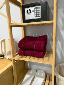 a shelf with a microwave and a pile of towels at Chaba CBP Chiang Mai in Chiang Mai