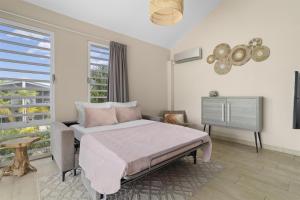 a bedroom with a bed and a television in it at Delfins Beach Resort Bonaire, Tapestry Collection by Hilton in Kralendijk