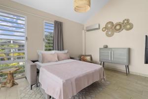 a bedroom with a bed and a television in it at Delfins Beach Resort Bonaire, Tapestry Collection by Hilton in Kralendijk +131 photos