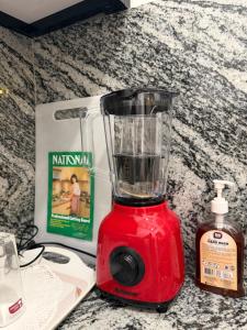 a red blender sitting on top of a counter at Earthora Escape in Dickwella