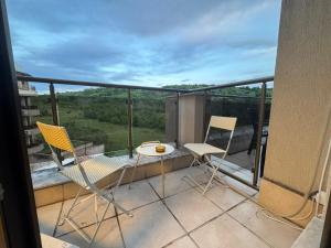 a balcony with two chairs and a table with a view at View of the forest in Veliko Tŭrnovo +17 photos