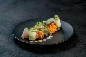 a plate of food with vegetables on a table at YŪN Uluwatu in Uluwatu