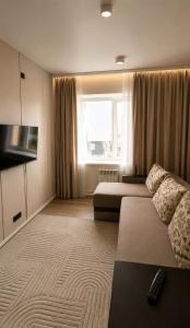 a hotel room with two beds and a television at Everest in Zyryanovsk