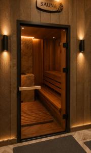 a sauna with a wooden door in a room at Everest in Zyryanovsk +33 photos