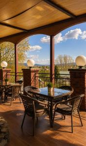 a patio with a table and chairs on a deck at Everest in Zyryanovsk