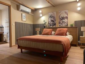 a bedroom with a large bed with orange pillows at Chambres d'Hôtes Barraconu in Porto-Vecchio
