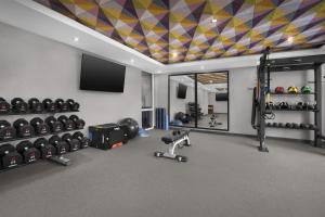 a room with a gym with dumbbells and a tv at Home2 Suites by Hilton Chelmsford Lowell in Chelmsford